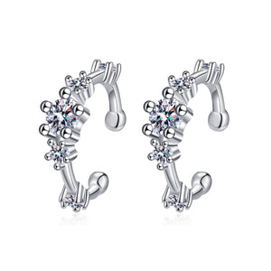 Silver earrings with floral designs and clear gemstones on a white background