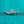 Silver ring with floral design on a turquoise glittery background