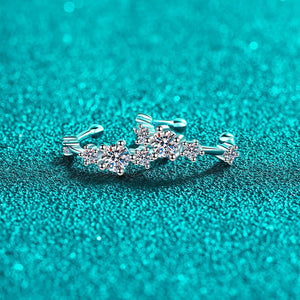 Silver ring with floral design on a turquoise glittery background