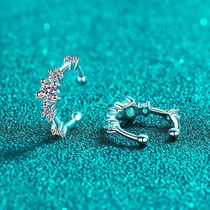 Silver hoop earrings on a teal glittery background