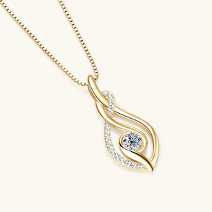 Gold necklace with a heart-shaped diamond pendant on a white background