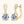 Gold earrings with large gemstones on a white background