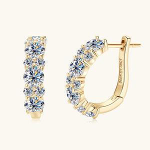 Gold hoop earrings with clear gemstones on a white background