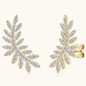 Gold earrings with diamond-like stones on a white background