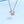 Silver necklace with geometric pendant on a light blue background