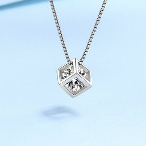 Silver necklace with geometric pendant on a light blue background