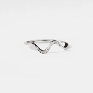 Silver ring with wavy design on a white background