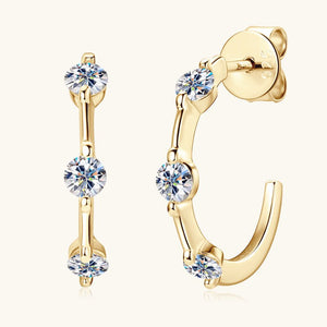 Gold hoop earrings with clear gemstones on a white background