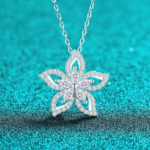 Silver butterfly pendant necklace on a turquoise glittery background