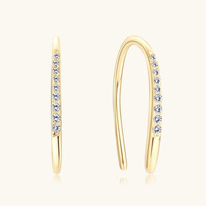 Gold hoop earrings with embedded diamonds on a white background