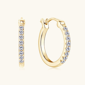 Gold hoop earrings with embedded diamonds on a white background