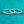 Two silver hoop earrings on a teal glittery background