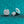 Silver earrings with gemstones on a teal glittery background