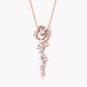 Rose gold necklace with a diamond-encrusted rose pendant on a white background