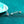 Silver earrings with gemstones on a teal background