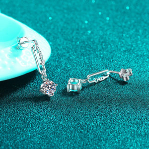 Silver earrings with gemstones on a teal background