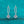 Silver earrings with gemstones on a teal glitter background