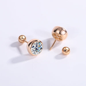 A pair of round moissanite screw back stud earrings set in a mount with a reflective silver finish.