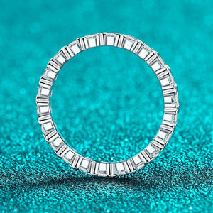 Silver ring with baguette diamonds on a turquoise glitter background