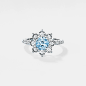 Silver ring with a blue gemstone on a white background