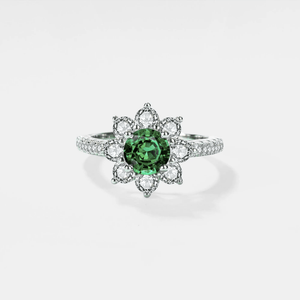 A moissanite gemstone set in a flower-shaped ring with a hypoallergenic platinum finish.