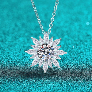 Silver necklace with a star-shaped diamond pendant on a turquoise background