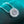 Silver necklace with a star-shaped pendant on a textured teal background