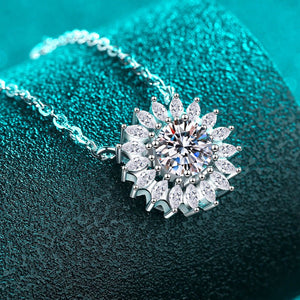 Silver necklace with a star-shaped pendant on a textured teal background