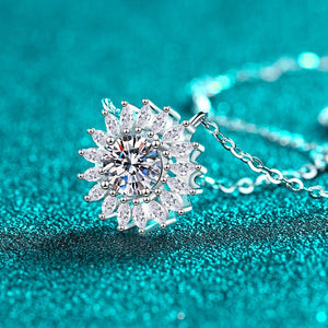 Silver necklace with a snowflake-shaped pendant on a teal background