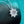 Diamond necklace on a dark surface with a teal background