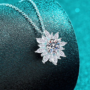 Diamond necklace on a dark surface with a teal background