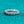 Silver ring with diamonds on a teal background