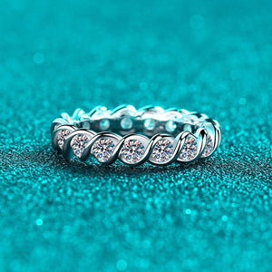Silver ring with diamonds on a teal background