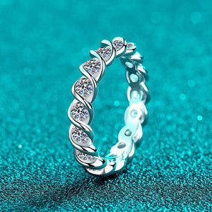 Silver ring with diamond accents on a teal background