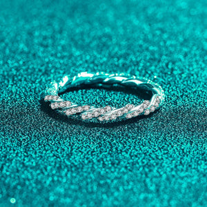Silver ring with small diamonds on a teal glittery background