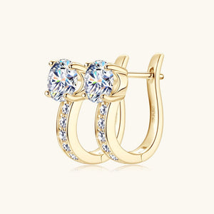 Gold hoop earrings with clear gemstones on a white background
