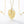 Gold leaf-shaped pendant with a pearl on a gold chain against a white background