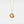 Gold necklace with a round locket featuring a moon face and star on a light gray background
