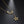 Gold necklace with a crescent moon and star pendant on a dark background