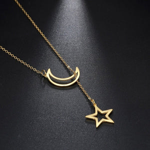 Gold necklace with a crescent moon and star pendant on a dark background