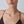 Gold necklace on a model against a neutral background