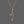 Gold necklace with star and moon pendants on a gray background