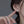 Close-up of a person wearing a small earring with a blurred background