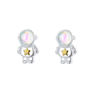 Silver astronaut earrings with a gold star on a white background