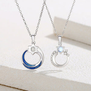 Two silver pendants on chains against a white background