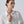 Woman wearing a white shirt against a plain background