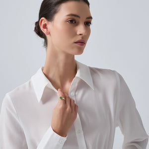 Woman wearing a white shirt against a plain background