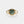 Gold ring with a green stone on a white background