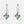 Silver earrings with green gemstones on a white background
