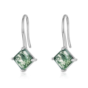 Pair of green square gemstone earrings on a white background